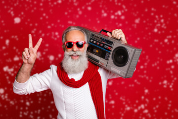 Portrait of his he nice handsome cheerful cheery positive carefree gray-haired man in pullover sweater having fun vintage festive showing v-sign isolated over bright vivid shine red background