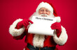 © Sameh - Xmas, santa claus in red costume and hat holding empty wish list with title merry christmas