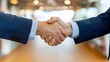 © Lens Legacy - Two individuals in suits engage in a formal handshake, epitomizing business connection and agreement in a polished business corridor environment, emphasizing professionalism.