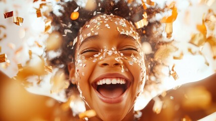 Wall Mural - A joyful child with a wide smile is covered in colorful confetti, capturing a moment of pure happiness and celebration with vibrant colors and playful joy.