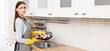 © Prostock-studio - Hand Cleaning. Sad young woman washing pan, wearing yellow rubber gloves, tired of household chores
