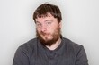© Tracy King - Contemplative Man with Beard in Casual Gray Shirt