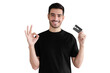 © Damir Khabirov - Young man in black t-shirt, holding credit card and showing okay gesture