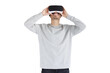 © Damir Khabirov - Young man holding virtual reality headset with both hands