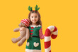 © Pixel-Shot - Cute little girl with teddy bear and Christmas cushion on color background
