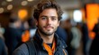 © Muamanah - Close-up portrait of a smiling young man with wavy hair and a beard