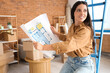 © Pixel-Shot - Beautiful woman with house plan in room on moving day