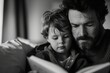 © Suplim - Father and Son Reading Together