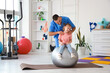 © Pixel-Shot - Male physiotherapist working with little girl on fitball in rehabilitation center