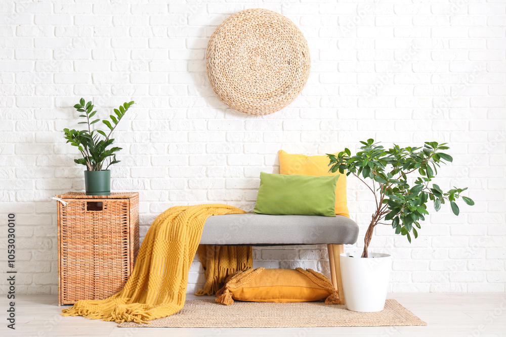 Interior of room with soft bench, basket and plants
