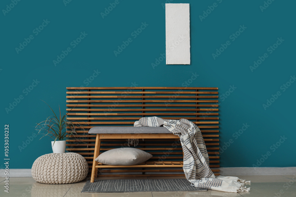 Interior of room with soft bench, pouf and folding screen