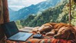 © Chatchanan - A digital nomad enjoying a mountain view, with a laptop plugged into a portable power