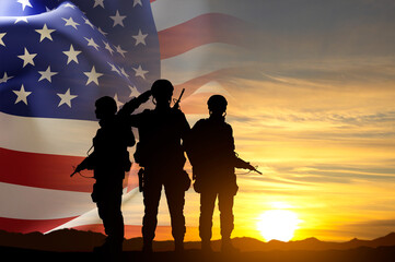 Wall Mural - Silhouettes of a soldiers with USA flag against the sunset. Veterans, Memorial Day concept