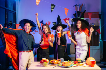 Joyful office Halloween party with coworkers in costumes, celebrating with drinks and laughter, fostering teamwork