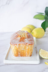 Wall Mural - freshly baked homemade lemon poppy seed pound cake on white ceramic tray.