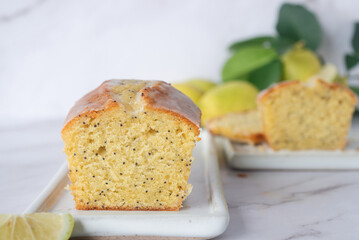 Wall Mural - freshly baked homemade lemon poppy seed pound cake on white ceramic tray.