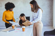 © Dragana Gordic - Stressed Businesswoman Supported by Colleagues in Modern Office