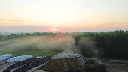 Green farm with hay bales and silage storage for winter feed