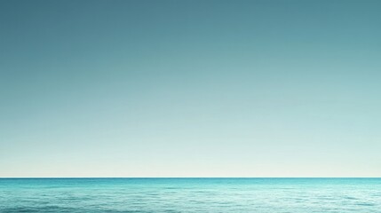 A serene seascape featuring a calm ocean under a clear sky.