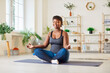 © Studio Romantic - Sporty yogi fit middle aged happy african american woman peaceful sitting in lotus pose with mudra gesture fingers, enjoying morning deep mindful meditation alone, smiling for balance harmony, relax