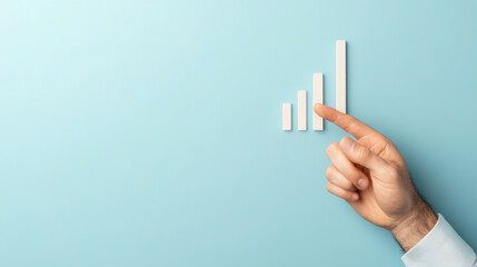 close up of hand pointing at rising bar graph on light blue background, symbolizing growth and progress in business trends