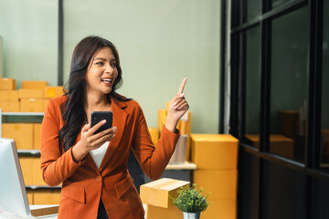 Happy young entrepreneur women presenting or pointing, happy working.