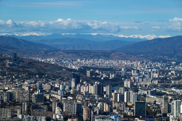 Wall Mural - Aerial panoramic view from Mtatsminda Park of Tbilisi, capital of Georgia, with snow-capped Caucasus mountains in the distance