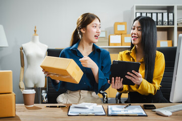 two young asian woman work in back office for checking the product in the warehouse, concept e comme