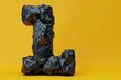© Phuriphat - The letter L is made of rocks and is on a yellow background