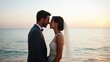 © Nitchalee N. - A romantic beach wedding scene with a couple sharing a kiss against a beautiful sunset and the tranquil ocean backdrop.