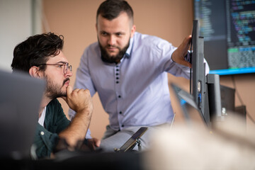 programmers engrossed in deep collaboration, diligently working together to solve complex problems