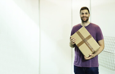 Young man delivery shipment blank cardboard package box deliver. Working with packages concept