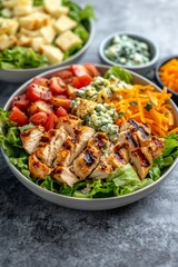 Healthy grilled chicken salad with fresh vegetables and cheese served in a bowl, perfect for a nutritious meal