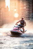 Jetski in water with background of large city skyline with skyscraper. Summer tropical sports.