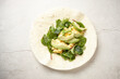© Austockphoto - Tortilla wrap on a white surface topped with avocado slices, spinach, and scrambled egg