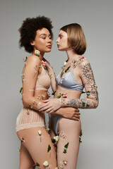 A loving embrace shared by two women, beautifully embellished with delicate flowers.