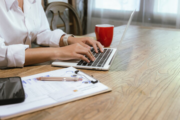 Close-up of businesswoman paying online with credit card