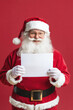 © Synthetica - A man in a red Santa suit holding a blank piece of paper. He is smiling and he is happy