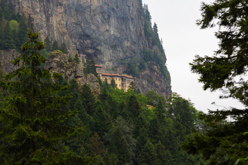 Wall Mural - sumela monastery view from the forest. visit turkey concept photo