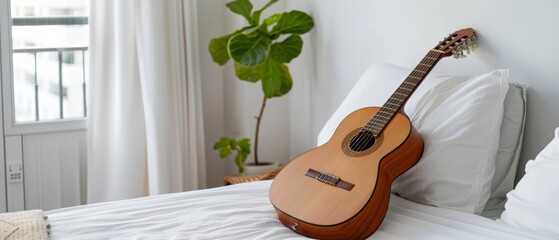 An elegant guitar rests on a bed, flanked by a leafy plant, creating a tranquil and artistic atmosphere.