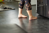 Naked women feet with leggings and lace indoors on a vinyl floor