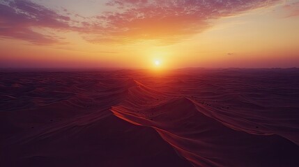 Wall Mural - A drone capturing footage of a sunset over the desert, with plenty of sky for copy space