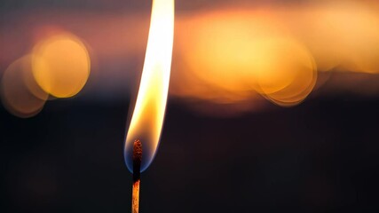 Wall Mural - burning match illuminating a stunning sunset bokeh background