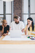 © BullRun - Group of shocked multiethnic coworkers using laptop at office
