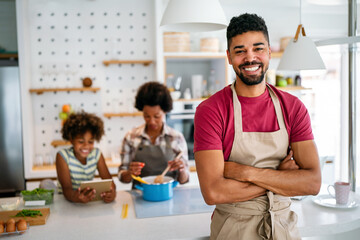 Wall Mural - happy african american family preparing healthy food in kitchen, having fun together on weekend