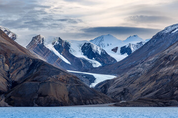 Wall Mural - a hanging glaciers in the mountains of kaiser franz joseph fjord, northeast greenland national park,
