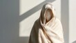 © PixelNexusArt - Person wrapped in heavy blankets despite midday sun through window, deep shadows across room, front angle