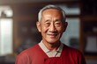 © Markus Schröder - Portrait of a happy asian elderly man in his 90s wearing a sporty polo shirt in scandinavian-style interior background