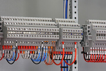 Electrical screw terminals for connecting wires in an electrical switchboard. Soft focus. Close-up.