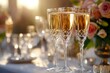 © woters - Elegant champagne flutes filled with sparkling wine set on a beautifully arranged table during a golden sunset celebration